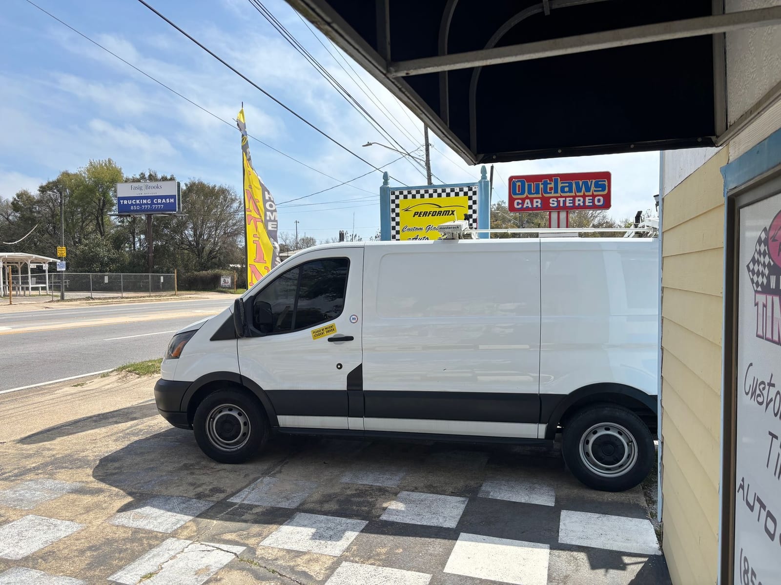 White commercial van with front window tint at the Pensacola shop