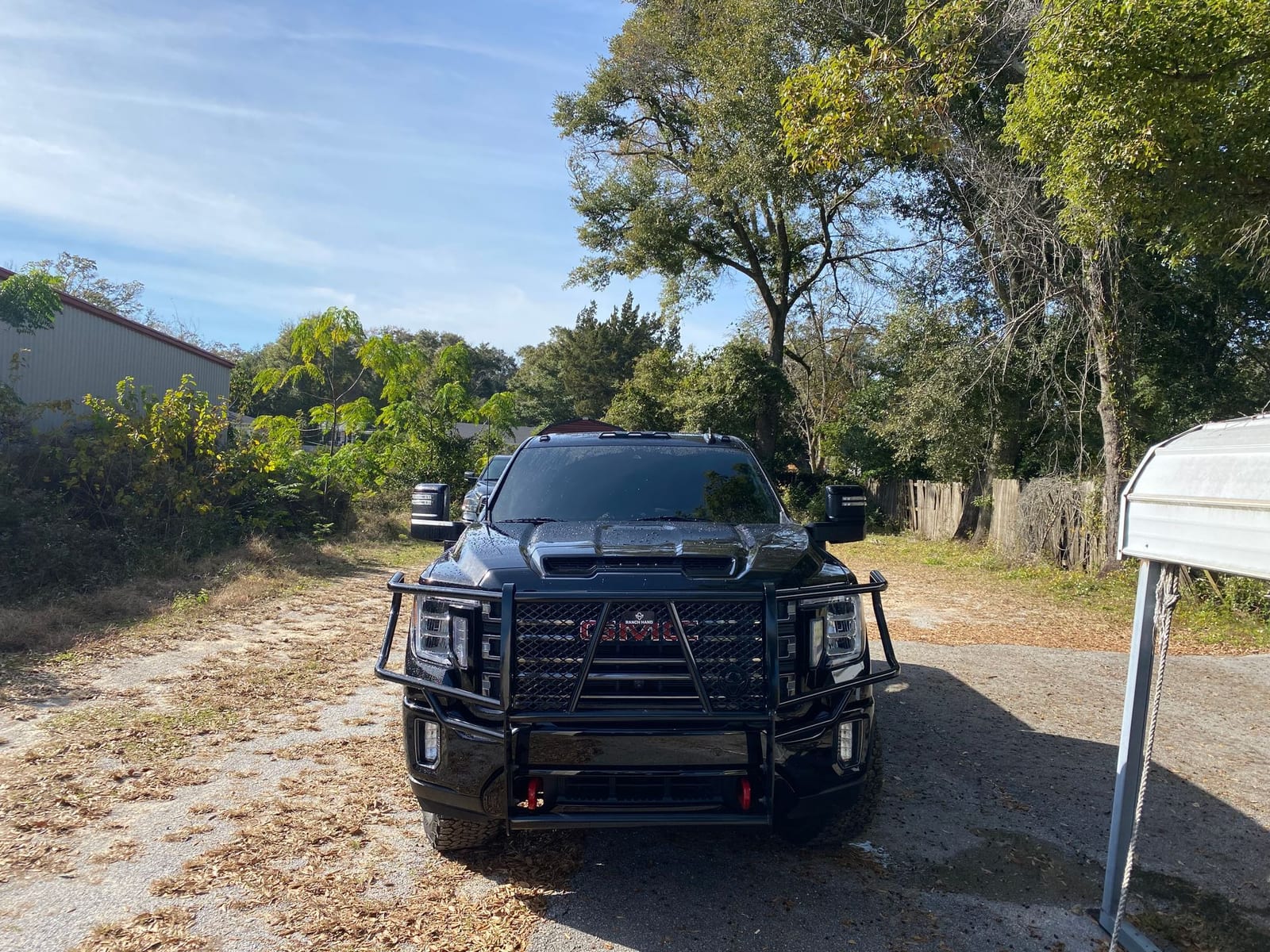 Black heavy-duty truck with tinted windshield and side glass